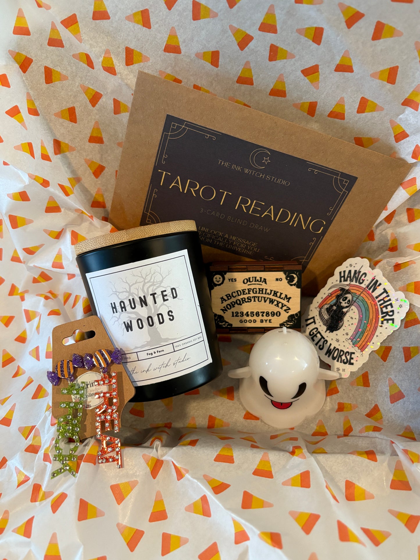 Trick or Treat Halloween Gift Set – "TRICK" or "TREAT" Dangle Earrings, Haunted Woods Candle, 3-Card Tarot Reading, Ouija Board Wooden Matchbox, Grim Reaper Sticker & Light-Up Ghost Perfect Gift for Halloween Lovers
